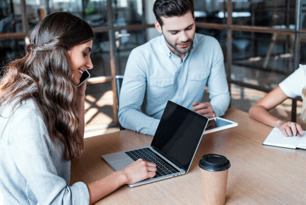 smiling young business colleagues working together in office